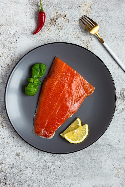 Half of salted salmon fillet on a gray plate Healthy eating