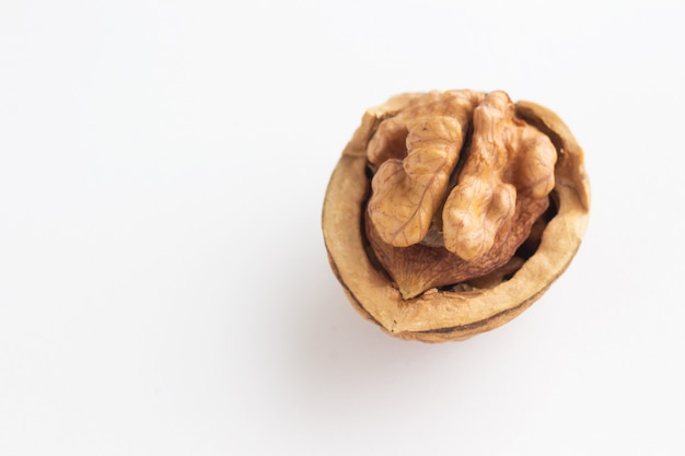 Half of a walnut on a white background