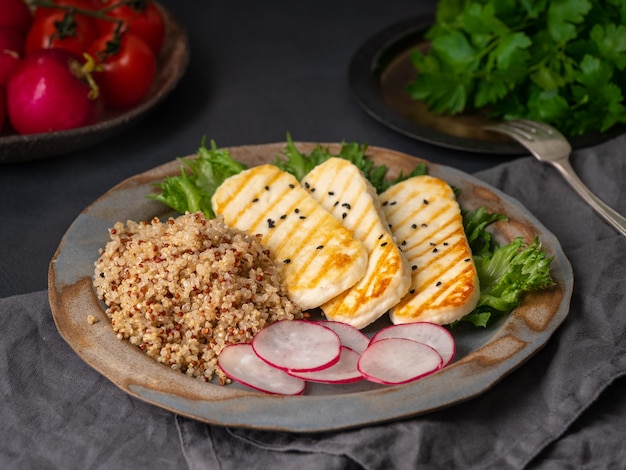 Halloumi, grilled cheese with quinoa, salad, radish. 