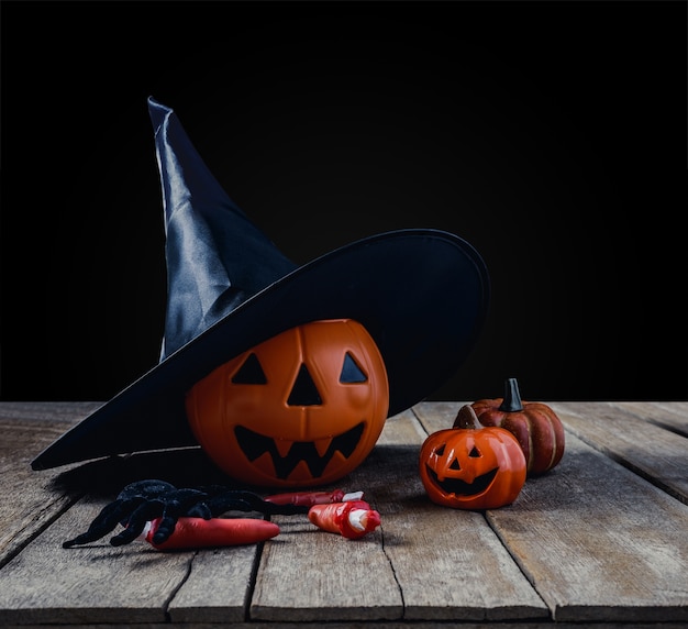 Halloween background with Pumpkins, Witch hat, Black spider, fingers