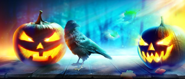 Halloween background with raven in a spooky night.