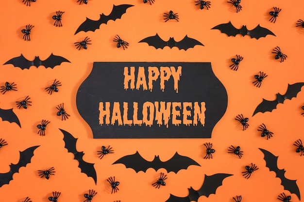 Halloween bats and spiders on orange 