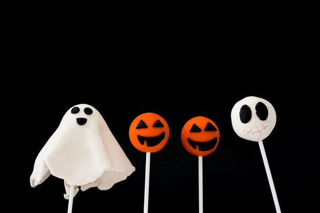 Halloween cake pops on black surface