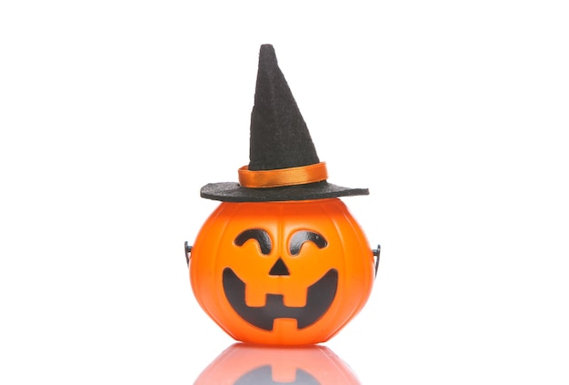 Halloween candy bucket with jack pumpkin face and witch hat isolated on white background with shadow