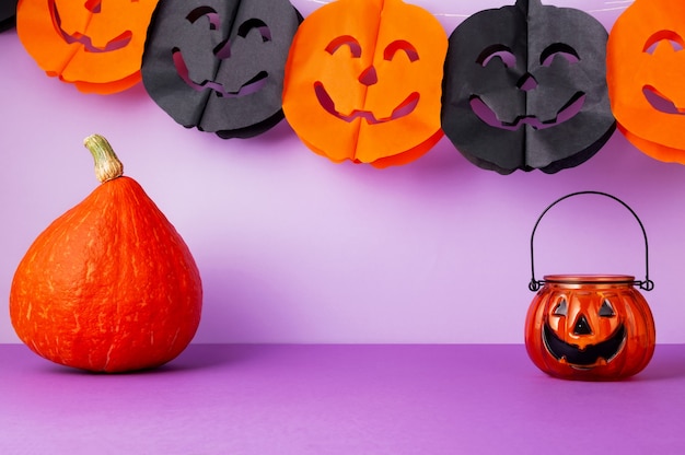 Halloween celebration. Pumpkins flashlight jack on  purple background