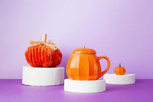 Halloween celebration. Various decarative pumpkins on white round podiums on purple background