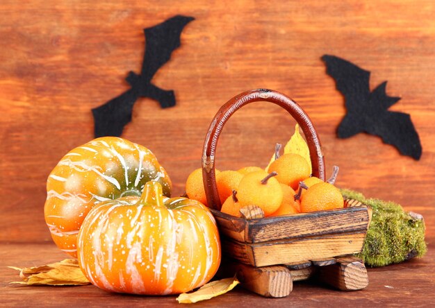 Halloween composition on brown wooden background