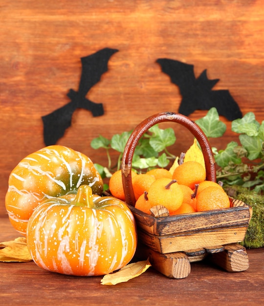 Halloween composition on brown wooden background