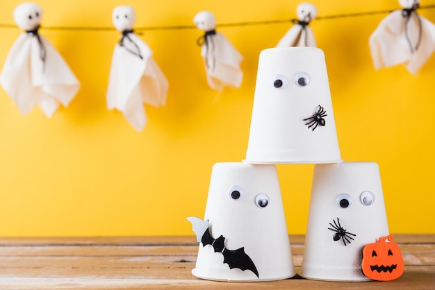 Halloween crafts paper cup ghost on wood