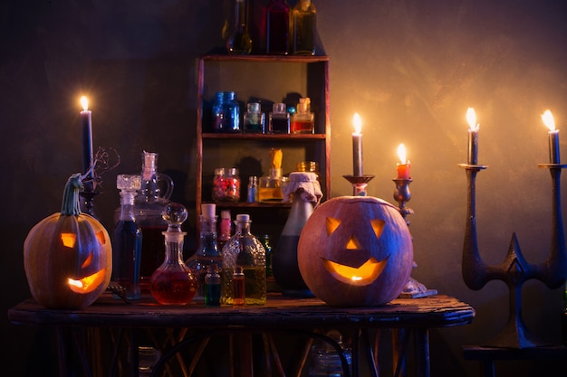 Halloween decoration with pumpkins and magic potions indoor