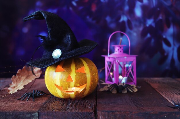 Halloween decorations, pumpkins and a lamp with a burning candle, Halloween celebration