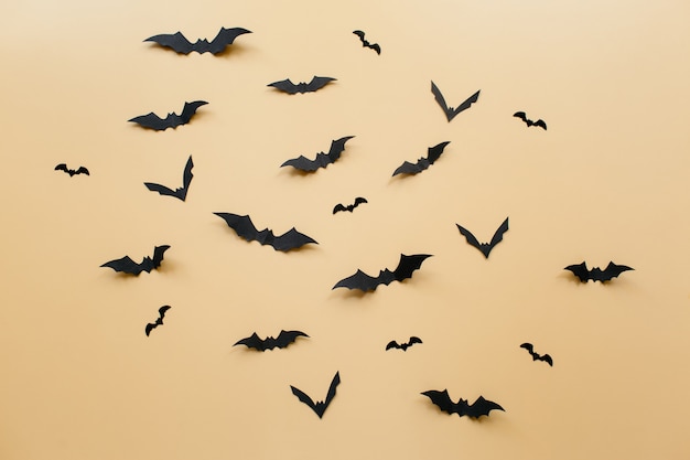 Halloween decorations with bats on pastel beige background halloween concept flat lay top view copy