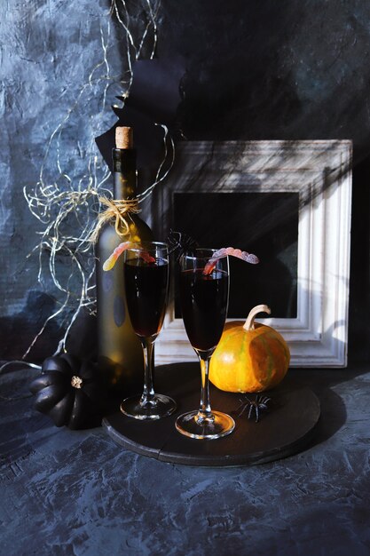 Halloween drinks wine pumpkins mystical decorations on a black background