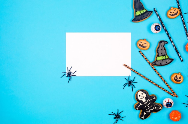 Halloween flat lay composition with pumpkins drink straws spiders confetti treat