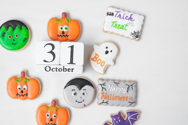 Halloween funny Cookies with 31 October calendar on white background. Trick or Threat, Happy Halloween, Hello October, fall autumn, Festive, party and holiday concept