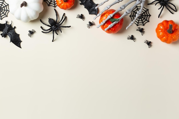 Halloween greeting card with bats spiderweb spider skull and pumpkins