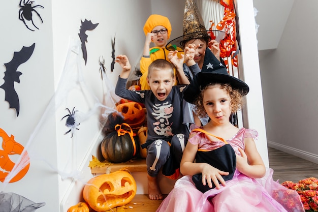 Halloween holiday party for children Kids in costumes on staircase