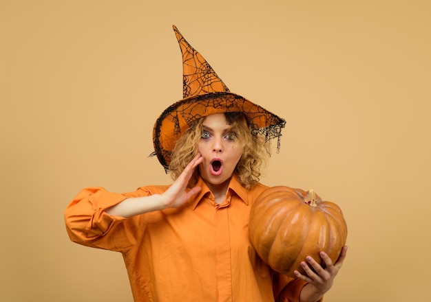 Halloween holidays october halloween costume for party woman in witch hat with pumpkin surprised