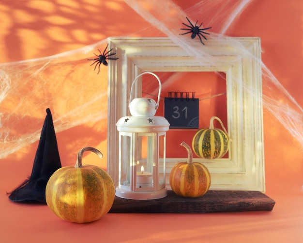 Halloween a lantern with a burning candle pumpkins a witch's hat of interior decoration