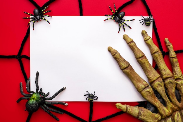 Halloween mock up blank sheet of paper with spiders web and monsters hand