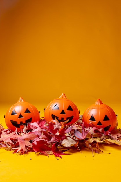 Halloween orange pumpkins on a yellow background autumn decoration