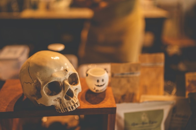 Halloween party concept decorate in cafe decoration with human skull and pumpkin in holiday