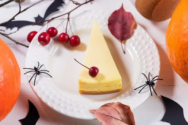 Halloween party table setting design with pumpkin pie pumpkins black spiders owls dry twigs