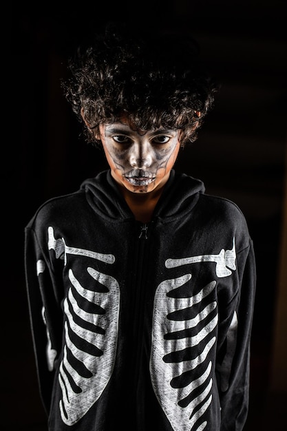 Halloween portrait of child with face painted by Jacko'lantern