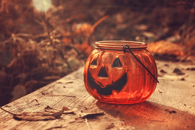 Halloween pumpkin candlestick on soft autumn backgound .