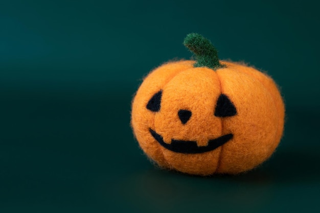 Halloween pumpkin on a green background closeup