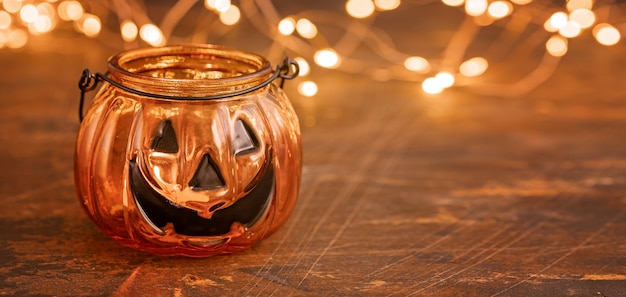 Halloween pumpkin head jack glass lantern. Halloween decoration on wooden table background, selective focus - Image