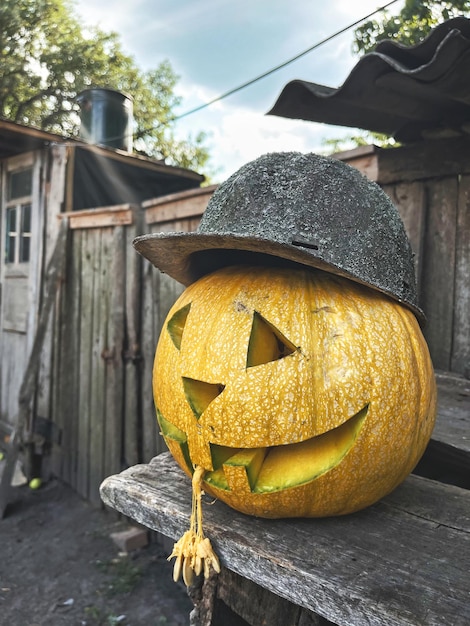 Halloween pumpkin in old hardhat and with tongue