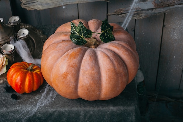 Halloween pumpkin with candles and cobwebs