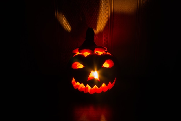 Halloween pumpkin with carved glowing face