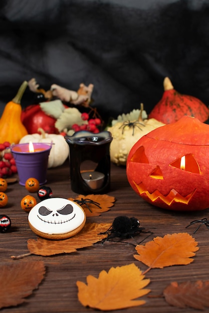 Halloween pumpkins on the background of a dark wall with ghosts bats spiders candles pumpkins leaves Selective focus