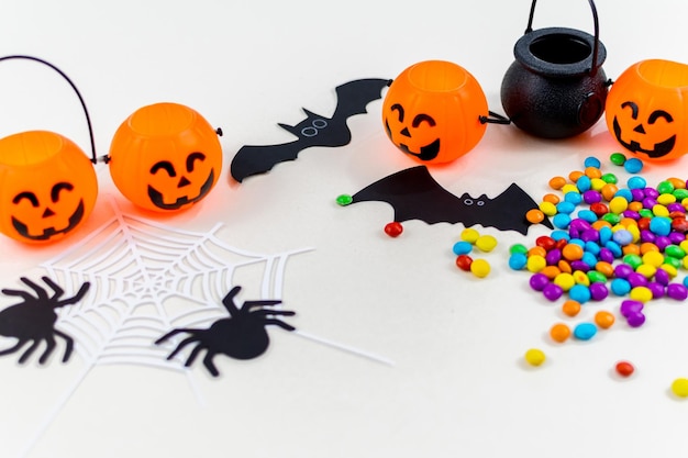 Halloween pumpkins bat silhouettes spider web silhouette and paper spiders on white background