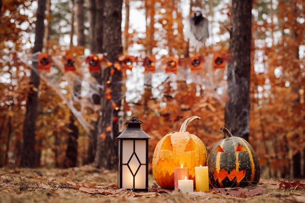 Halloween pumpkins candles in bright Autumn park Celebrating halloween