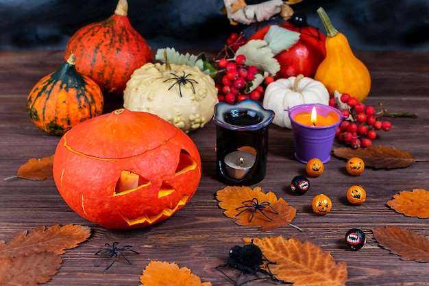 Halloween pumpkins on a table with spiders candles pumpkins