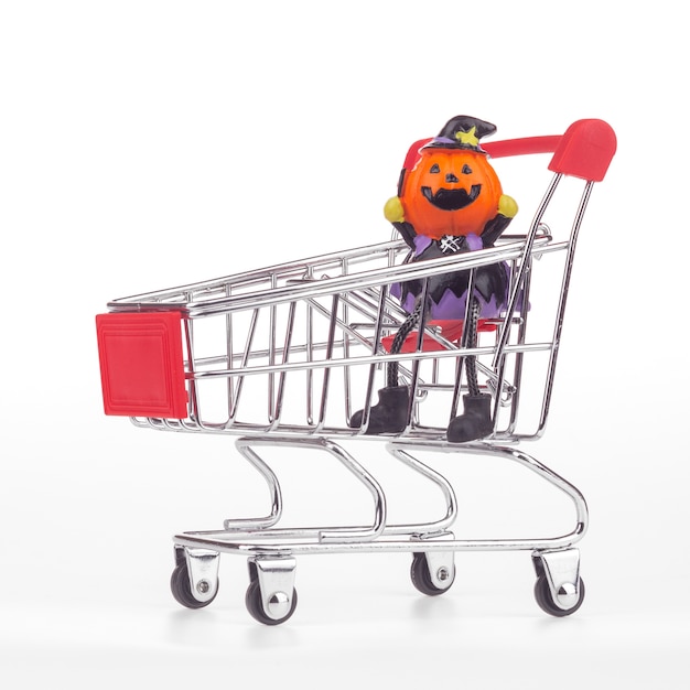 Halloween pumpkins toys in shopping cart on white 