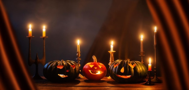 halloween pumpkins with burning candles on dark background