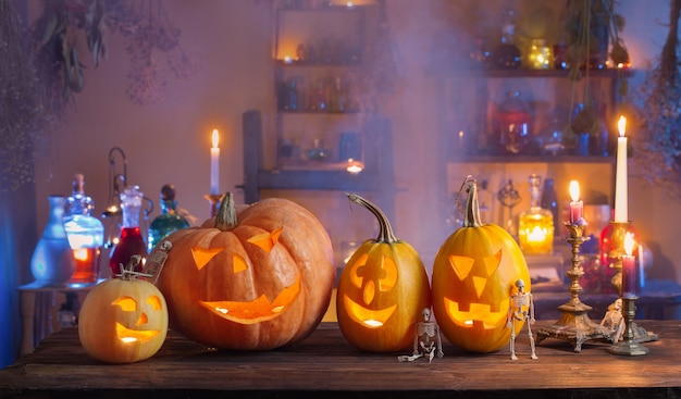 Halloween pumpkins with candles and magic potions