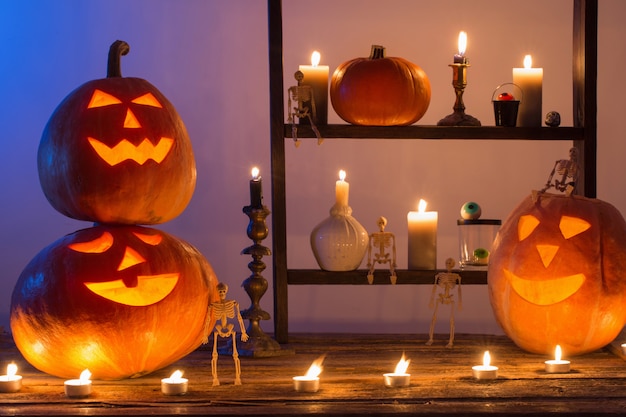 Halloween pumpkins with candles on wooden table