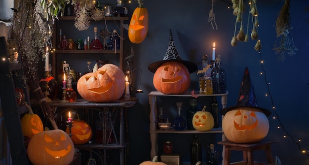 Halloween pumpkins with lights and burning candles and magic potions in witch's house