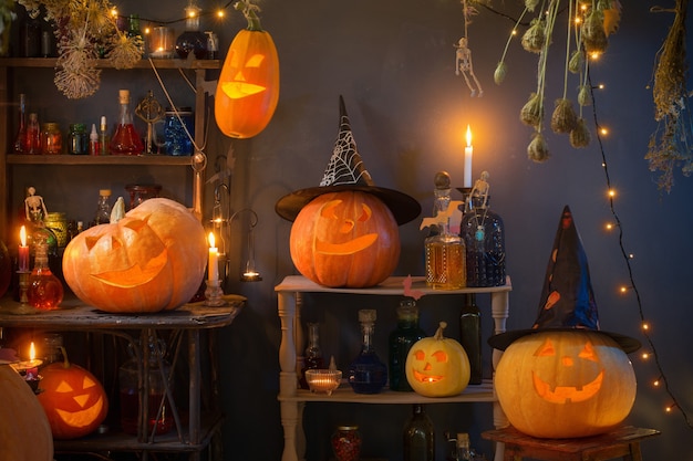 Halloween pumpkins with lights and  burning  candles and magic potions in witch's house