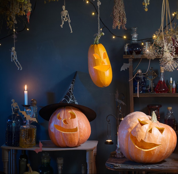 Halloween pumpkins with lights and  burning  candles and magic potions in witch's house