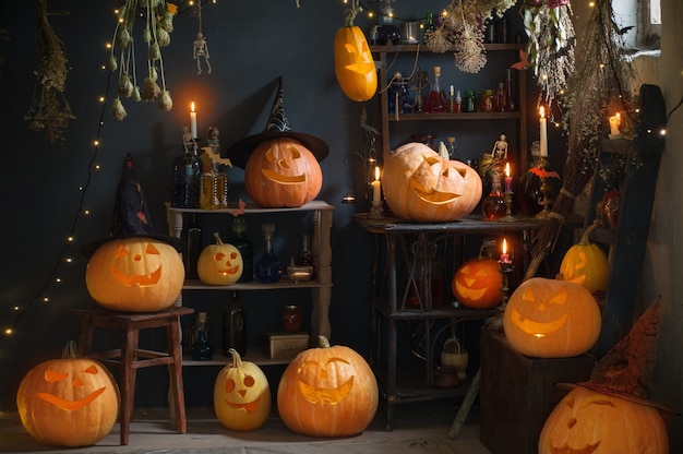 Halloween pumpkins with lights and  burning  candles and magic potions in witch's house