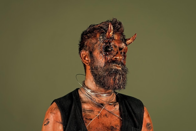 Halloween satan with red blood eyes beard wounds on face