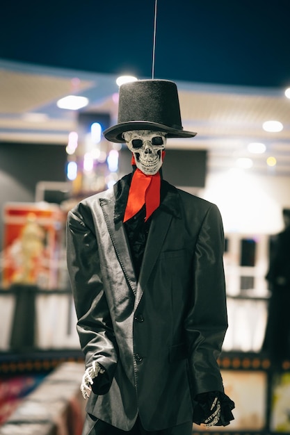 Halloween scenery Skeleton in a black suit and hat indoors looking at the camera Halloween concept