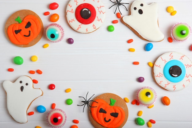 Halloween sweets on colored background close up top view with place for text