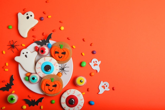 Halloween sweets on colored background close up top view with place for text